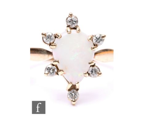 A 9ct hallmarked opal and diamond cluster ring, central, claw set, tear shaped opal detailed with six diamond to border, weig