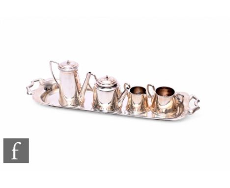 A hallmarked silver miniature four piece tea set and elongated rectangular twin handled tray, weight 73g, Birmingham 1972.
