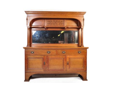 A Victorian late 19th century Arts &amp; Craft oak mirror back sideboard credenza. Having a flared rectangular top with a car