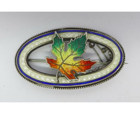 A silver and enamel brooch 