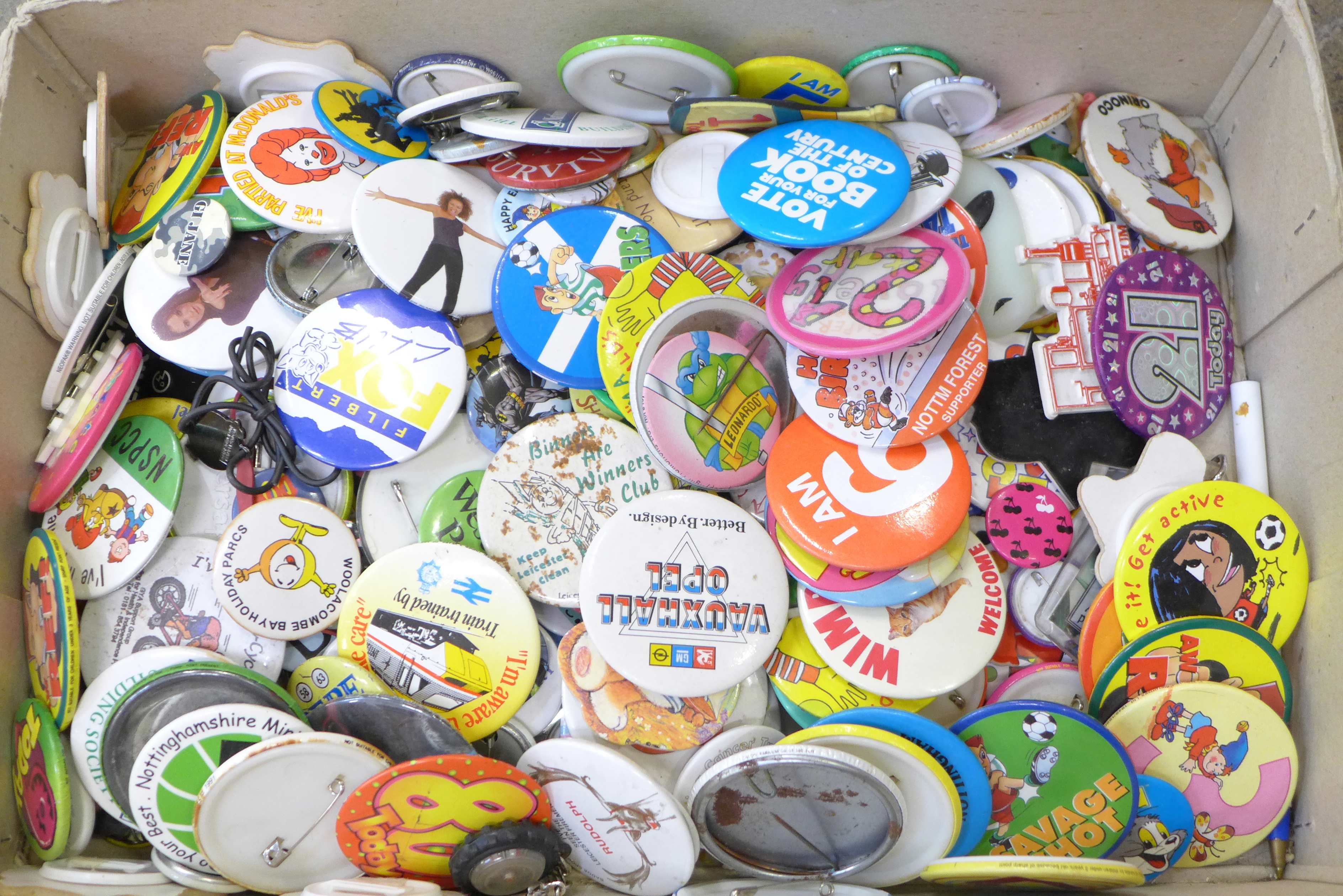 A large collection of pin badges