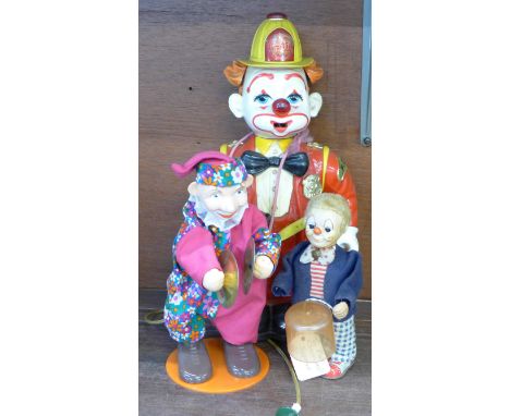 A plastic novelty light up clown figure, a 1950's Japanese clockwork clown and a clown cymbal player 