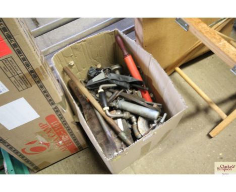 A cardboard box containing various hand tools etc.