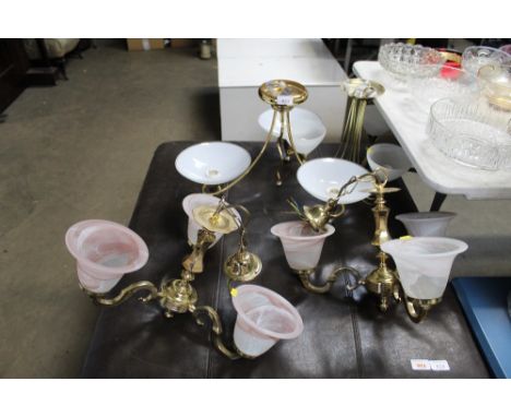A pair of brass three branch light fittings with glass shades and two others