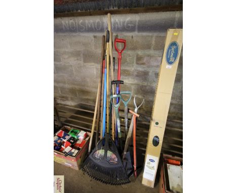 A quantity of long handled garden tools to include racks, forks, hoes, spades etc. 