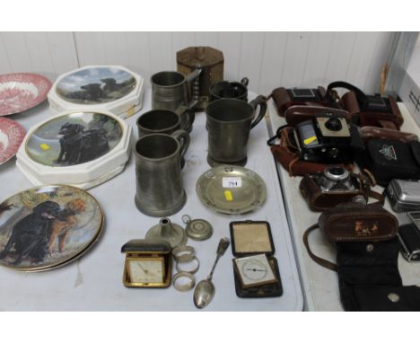 A silver plated watch case, pewter tankards, vintage tin, travel clocks etc.