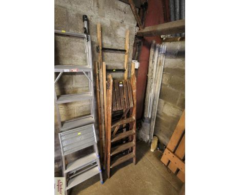 A three stage wooden extending ladder and a wooden five step folding set of steps