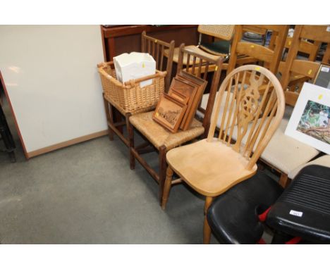 A pair of rush seated chairs together with a stick and wheelback chair