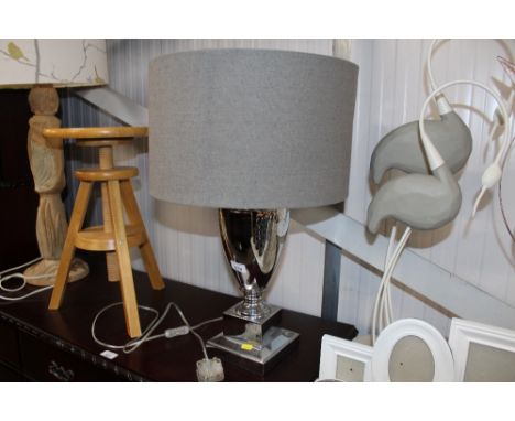 A modern table lamp with grey shade