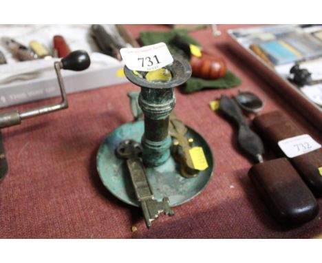 A chamber stick; ornamental key and a set of sovereign scales