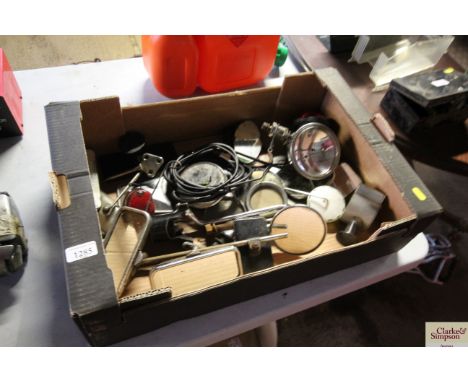 A box containing various vintage car mirrors, lamps, etc.