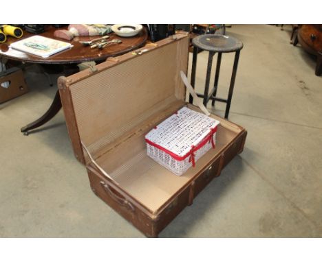 A wooden and metal bound travelling trunk together with a wicker basket