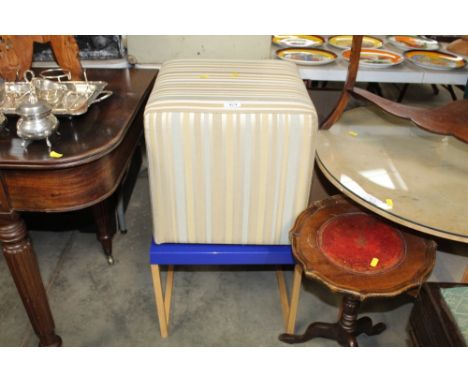 A modern upholstered pouffe and a side table