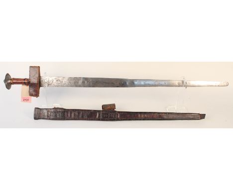 A 19th Century North African/Sudanese sword with embossed leather scabbard (as found)