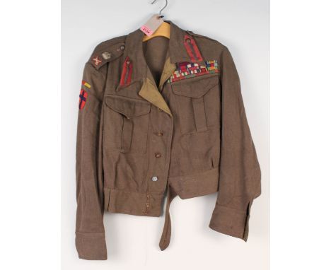 A WWII British Officers battle dress blouse (private purchase) with an impressive display of medal ribbons