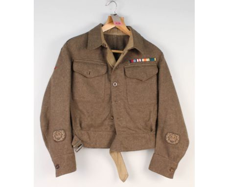 A WWII era (dated Sept 1942) battle dress blouse, 1940 patt with insignia for Warrant Officer H.A.C. found in breast pocket, 