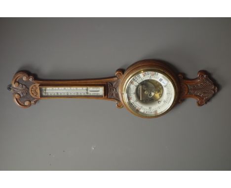 Early 20th century oak cased aneroid barometer with visible mechanism, enamel ceramic dial, mercury thermometer, 'J. Wetherel