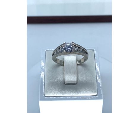 A 9ct white gold cz stone set ring,size R,weight is 4.6 grams approx,inside band engraved true diamonds but stones test as no