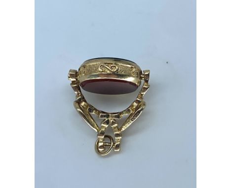 A 9ct yellow gold Victorian style swivel watch fob,set with a cornelian stone and a blood stone,28mm x 18mm,weight is 5 grams