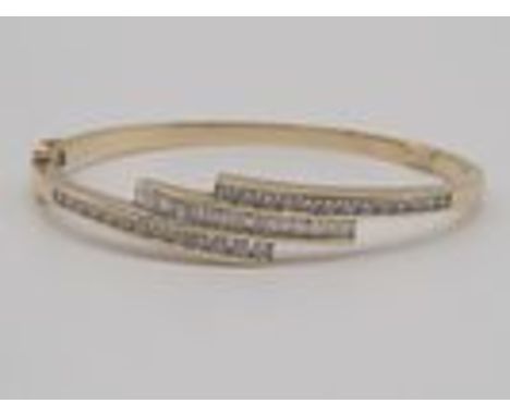 A 9ct Yellow Gold Diamond Bangle,Set with round brilliant cut diamonds + Baguette Cut Diamonds,approx 2.0cts total diamonds,1