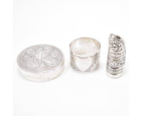 A 20th Century Brunei South East Asian silver trinket box together with a similar napkin ring and silver ring. The box of rou