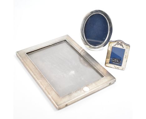 A collection of silver fronted photo frames. The lot to include an Edwardian silver photo frame with engine turned decoration