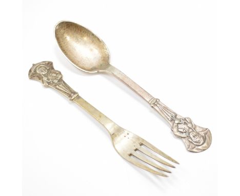 A matching 20th Century Danish silver Evald Nielsen spoon and fork set. The set having moulded terminals depicting a figure b