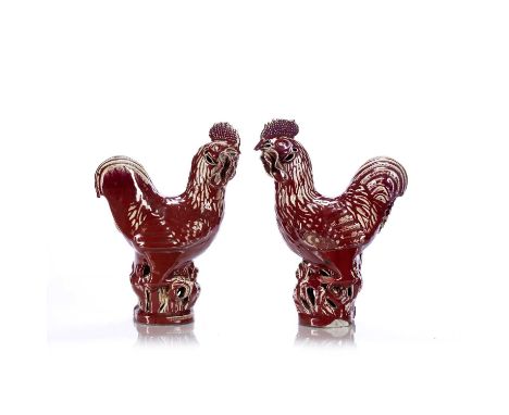 Pair of sang de boeuf model cockerelsChinese, 19th Centuryeach standing on a pierced base 35.4cm highCondition report: Some c