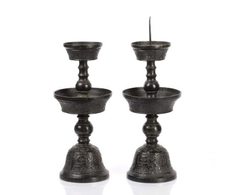 Pair of bronze Ming style temple candlesticksChinese, 19th Centurymodelled as a ribbed and bulbous stem mounted with two circ