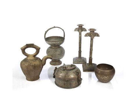 Group of metalware Islamic, 19th/20th Centurycomprising of a pair of candlesticks, 33.5cm high, an engraved bowl, 13cm across