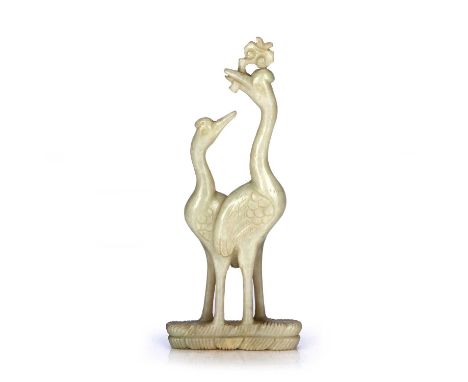 Hardstone model of two storksChinesewith their heads raised, supported by a grassy base, 15cm high, with an associated caseCo