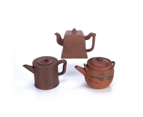 Three Yixing teapotsChinese, 19th/20th Centuryto include a cylindrical teapot with lines of calligraphy, seal mark inner stra