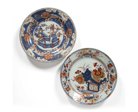 Two Imari chargersChinese, 18th Centuryone with rockwork, chrysanthemums and peonies 34cm, the other with temple, fence and p