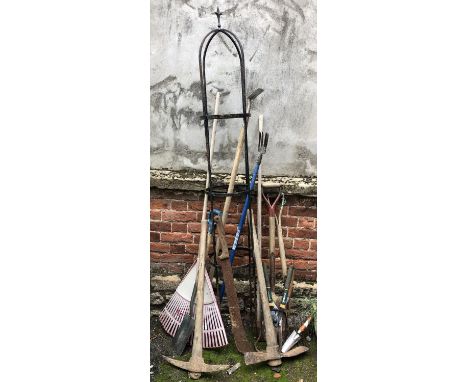 A wrought iron garden rose trellis, 205cmH, together with a selection of garden tools 