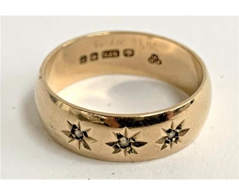 A 9ct gold gypsy ring set with three small diamonds with engraved star detail, approx. 3.3g, size L 1/2, hallmarked for Londo