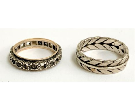 An Art Deco silver and gold eternity ring set with paste (some missing); together with a white metal ring with barleytwist de