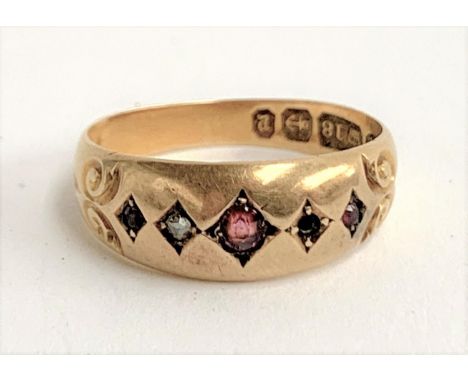 An 18ct gold gypsy ring set with garnets and a diamond (one diamond missing), approx. 2.9g, size L, hallmarked for Birmingham