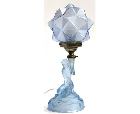 An Art Deco Walther &amp; Sohne table lamp, modelled as a nymph on a rocky outcrop supporting a faceted geometric blue glass 
