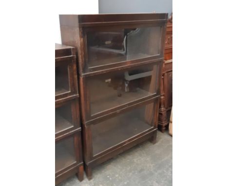 An oak Globe-Wernicke four section bookcase, each section with plaque, 88x29x136cm 