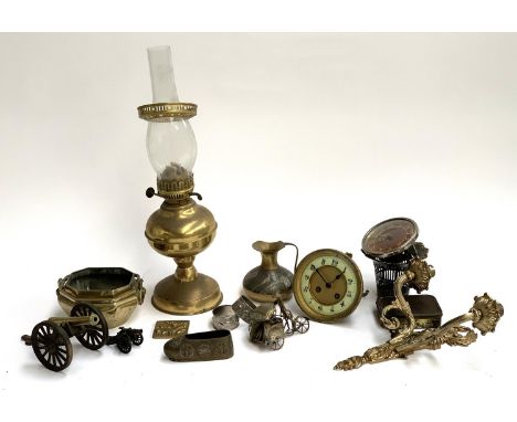 A mixed lot of mainly metal items to include die cutting pieces; model cannons; oil lamp; wall sconce etc 