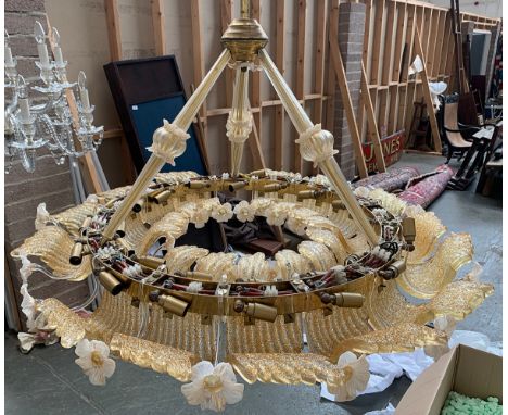 A Venetian glass chandelier, the central ring having interior and exterior fittings, each covered by golden 'wing', intersper