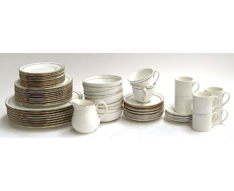 A Royal Worcester plain gilt part dinner service; together with a set of coffee cans and saucers 