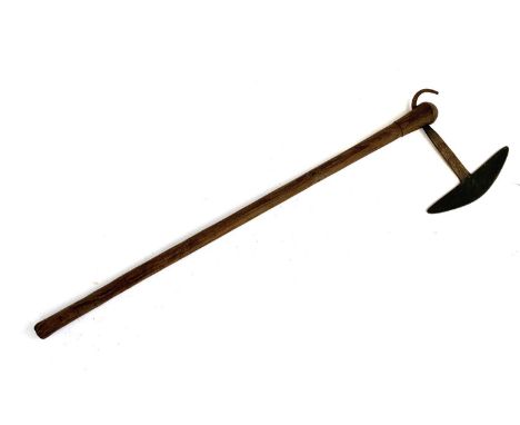 An African possibly Zulu tribal battle axe, the tang with fan shaped head and upward curved spike with cross hatch marks, 73c