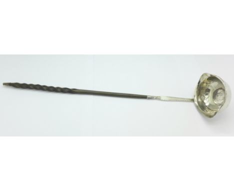 A ladle with whalebone handle, inset with a George III coin