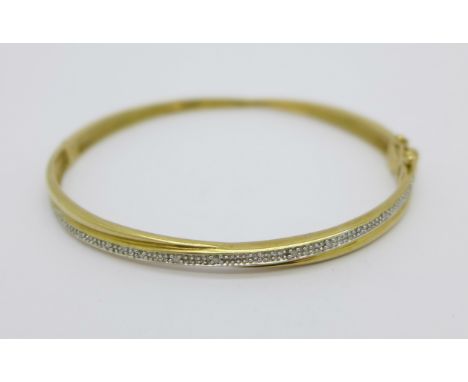 A yellow metal, diamond set bangle, 9.2g