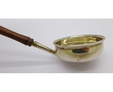 A white metal ladle inlaid  with a bank token coin dated 1811