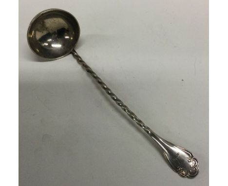 EDINBURGH: A large Scottish Victorian silver ladle with spiralled handle and crested decoration. 1845. Approx. 106 grams. Est