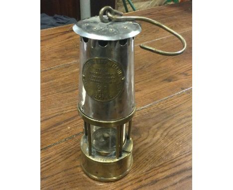 An old miner's lamp. Est. £20 - £30.