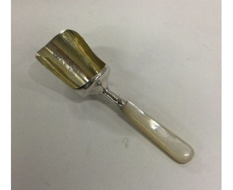 A silver and MOP caddy spoon. Birmingham 1906. Approx. 10 grams. Est. £50 - £80.