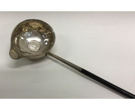 A Georgian silver toddy ladle with whalebone handle. Approx. 44 grams gross. Est. £20 - £30.